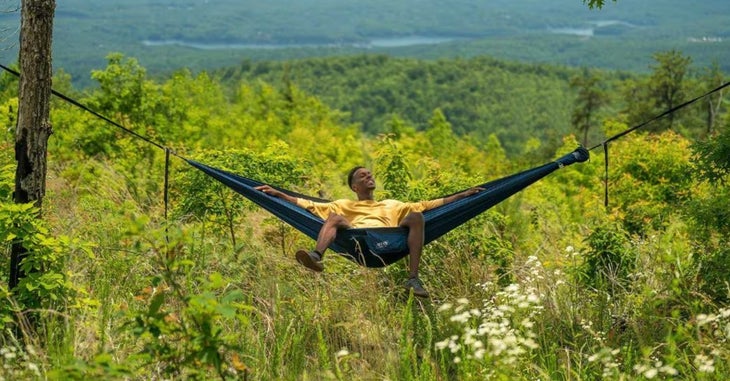 Man in hammock with forest background